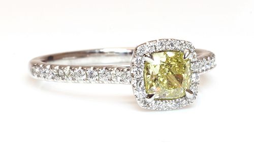 A platinum fancy yellow diamond and diamond halo cluster ring,