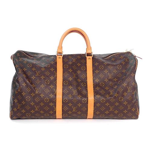 LOUIS VUITTON - a Keepall 55 Luggage Bag. Featuring maker's classic monogram coated canvas exterior