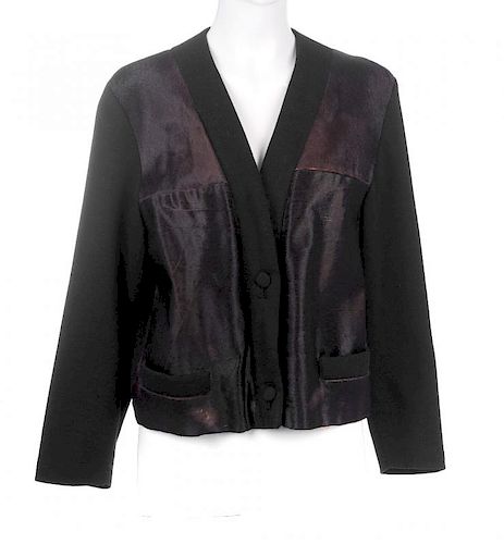A pony skin cardigan. The black v-neck cardigan designed with brown pony skin front panels, button f