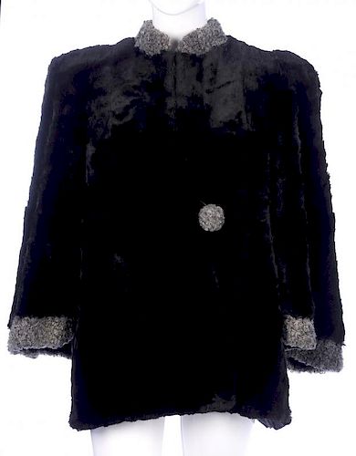 A 1930s sheared musquash fur cape. Designed with grey astrakhan trim, a short Mandarin collar, broad