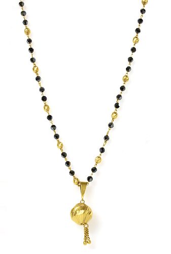 An Indian high carat gold pendant and chain,