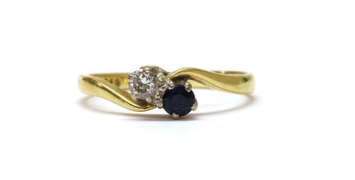 An 18ct gold two stone diamond and sapphire crossover ring,