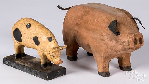 Carved and painted pine pig and a composition pig