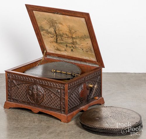 Regina music box with carved oak case and 24 discs
