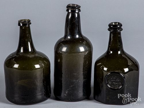 Three olive glass bottles