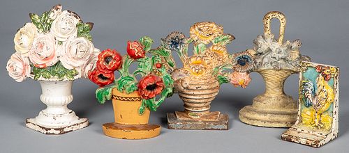Four cast iron floral doorstops, early 20th c.
