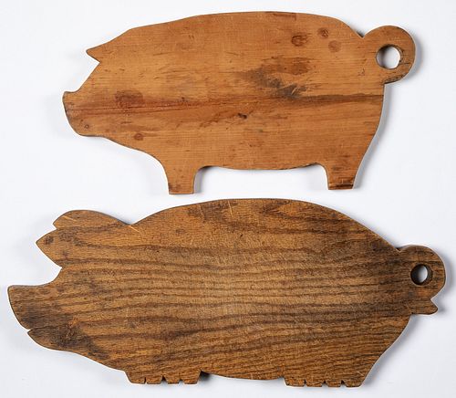 Two wooden pig cutting boards