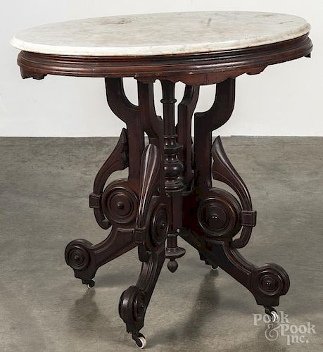 Victorian walnut parlor table, with a white marble top, 28 1/2'' h., 29 1/2'' w.
