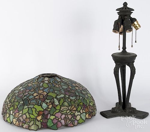 Slag glass table lamp, early 20th c., with a bronzed spelter base and animal paw feet, 23'' h.