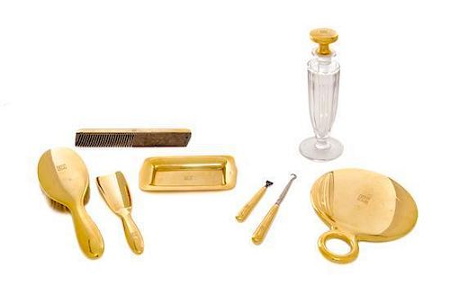 * An American 18 Karat Gold Mounted Nine-Piece Dressing Set, Tiffany & Co., New York, NY, Circa 1925, all engraved with an art d