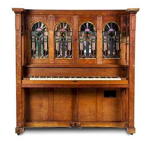 * A Marquette Cremona Style K Oak and Stained Glass Orchestrion, CIRCA 1915, SERIAL NO. 11527, Height 66 x width 64 1/2 x depth