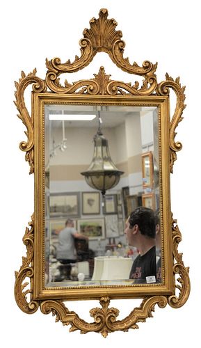 Chippendale style mirror with gold frame, height 54 inches, width 30 inches.