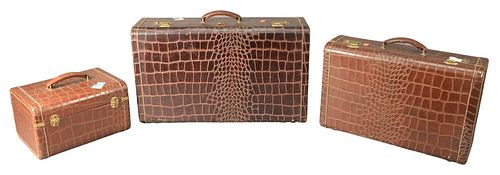 Set of Three LLeather Travel Suitcases, height 15 inches, largest width 26 inches.