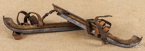 Pair of early iron and wood ice skates, 19th c.
