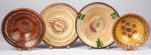 Four Continental redware slip decorated bowls