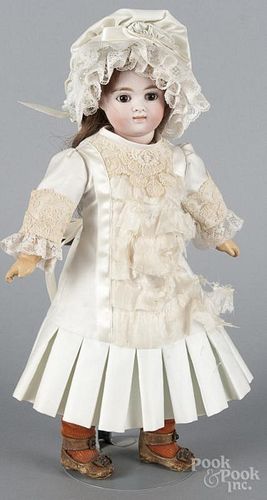 Bisque head doll, unmarked, with brown paperweight eyes, a closed mouth