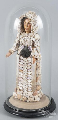 Victorian seashell doll, late 19th c., with a carved and painted face, under a dome, 11'' h.