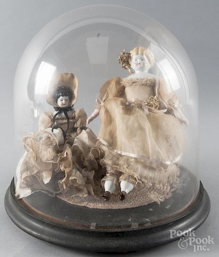 Two German bisque molded head and shoulder dolls, 19th c., under a dome, 12'' h. and 16'' h.