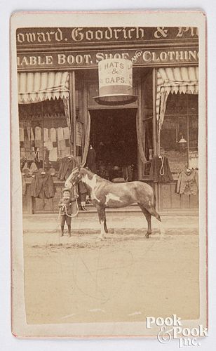 Photo of a storefront with large hat trade sign