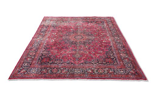 A LARGE PERSIAN MASHAD CARPET, the red ground with traditio