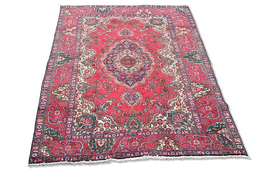 A PERSIAN TABRIZ CARPET, the multi-coloured ground with flo