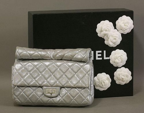 A Chanel iridescent silver quilted reissue roll clutch