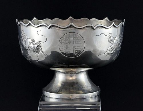 Chinese silver bowl with wavy rim, engraved with dragons and characters, on round foot,