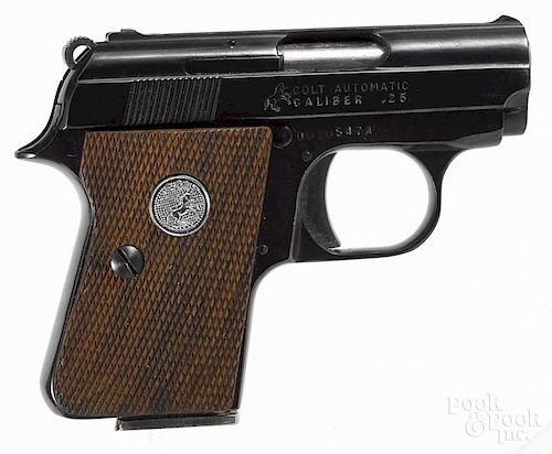 Colt semi-automatic pistol, .25 ACP caliber, blued with walnut grips and a visible hammer