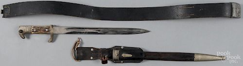 German WWII E. F. Horster eagle head dagger with a bone grip, a leather scabbard, and a hanger