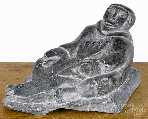 Inuit carved soapstone, 20th c., of an Eskimo and seal, 4 1/4'' h., 7'' w.