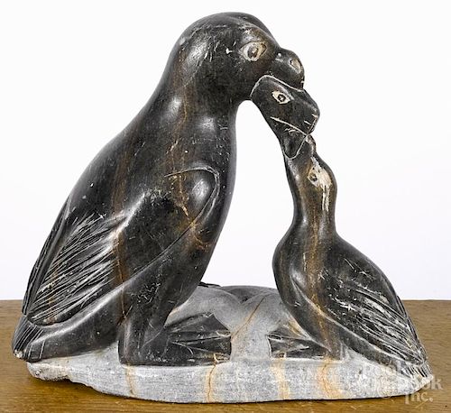 Inuit carved soapstone penguin feeding young, signed Kevin Mann '78, 7'' h.