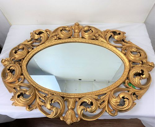 A Gold Framed Ellipse Shape Mirror