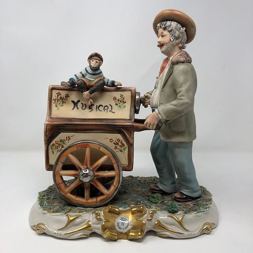 Capodimonte man statue pushing music box with Monkey