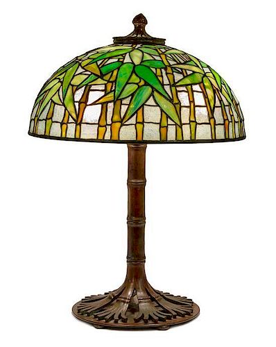 A Tiffany Studios Favrile Glass and Bronze Bamboo Table Lamp Diameter of shade 16 inches, height overall 22 1/2 inches.