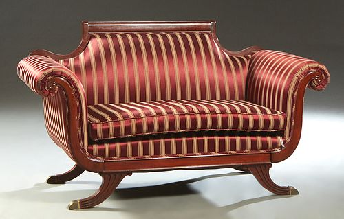Duncan Phyfe Style Carved Mahogany Settee, 20th c., the canted back with an arched crest rail, to large rolled arms, over a removable seat cushion, on