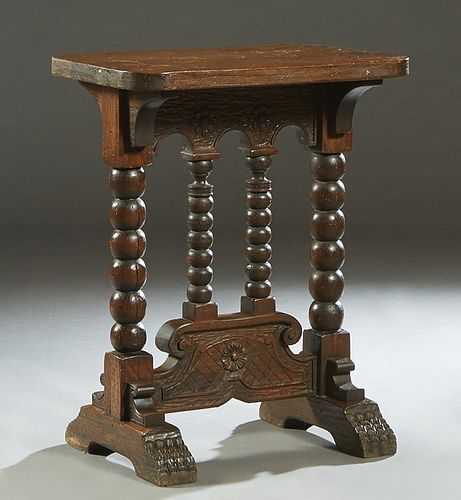 Continental Bobbin Turned Oak Side Table, late 19th c., the rounded edge rectangular top on bobbin turned trestle legs,with lappet carved splayed feet