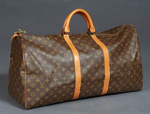 Louis Vuitton Keepall 60 Travel Bag, in a monogram coated canvas, with vachetta leather accents and golden brass hardware, opening to a brown canvas l