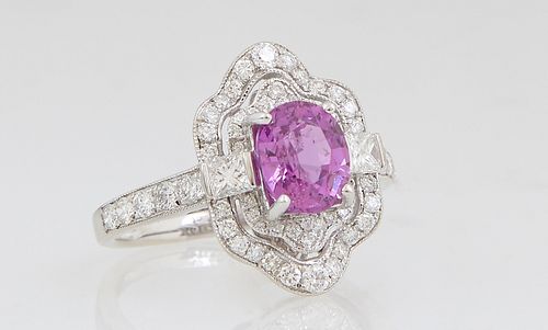 Lady's 14K White Gold Dinner Ring, with a 1.6 carat oval pink sapphire, atop a double pierced diamond mounted cartouche border, the lugs with princess