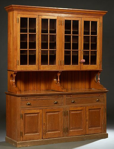 Large Carved Cypress Hutch, 20th c., New Orleans, the ogee crown over two pair of mullioned glazed doors, on turned tapered supports to a base with tw