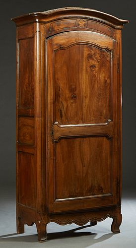 French Provincial Louis XV Style Carved Walnut Armoire, 19th c., the stepped arched rounded corner crown over an arched double panel door with an iron