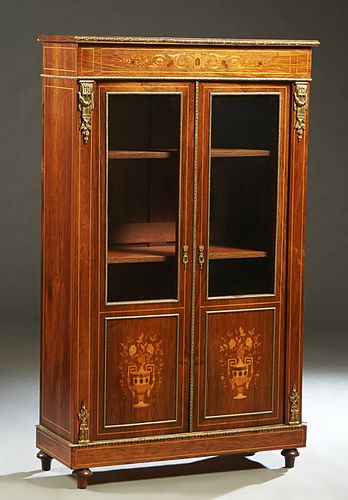 French Ormolu Mounted Louis XVI Style Inlaid Kingwood Bookcase, early 20th c., the rectangular top over setback double doors with glazed upper panels 