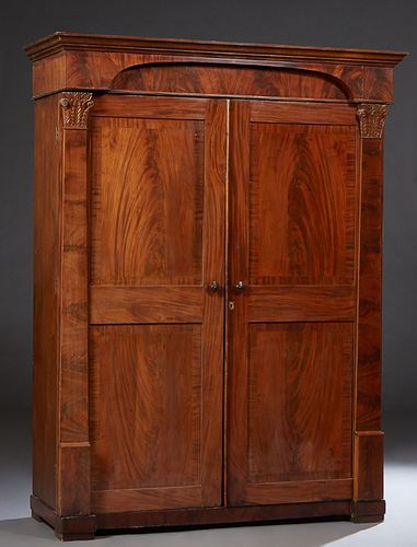 American Classical Carved Banded Mahogany Armoire, c. 1850, Philadelphia or New York, the stepped crown over an arched setback frieze atop double two 