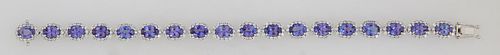 14K White Gold Link Bracelet, each of the eighteen oval links with an oval tanzanite atop a border of tiny round diamonds, total tanzanite wt.- 14.25 
