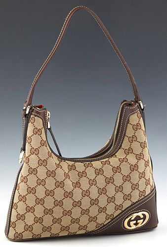 Gucci Mini Britt Hobo Bag, in beige monogram canvas with dark brown leather accents and gold hardware, opening to a red striped canvas lined interior 