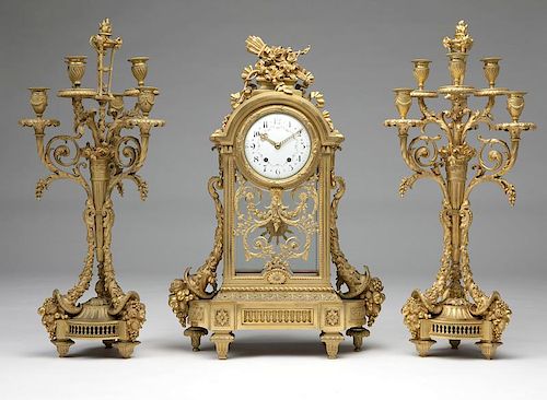 A Louis XVI-style gilt-bronze clock and garniture