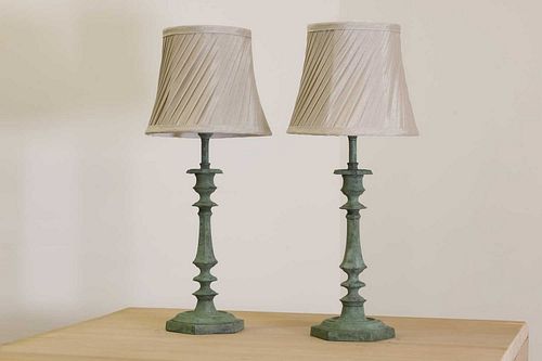 A pair of verdigris candlestick lamps,