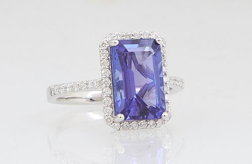 Lady's 14K White Gold Dinner Ring, with a 4.16 carat emerald cut tanzanite, atop a border of tiny round diamonds, the shoulders of the band also mount