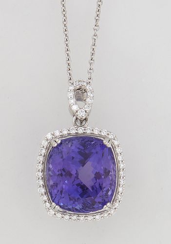 Platinum Pendant, with a 21.23 carat cushion cut tanzanite atop a conforming border of small round diamonds, with a pierced marquise shaped diamond mo