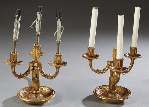 Pair of Brass Three Light Candelabra Lamps, 20th c., the three relief leaf form arched arms emanating forma reeded support, topped by fletching, on a 