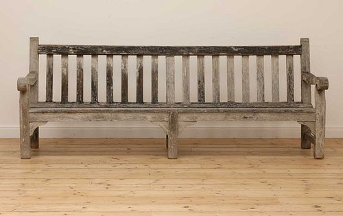 A large weathered teak country house bench,